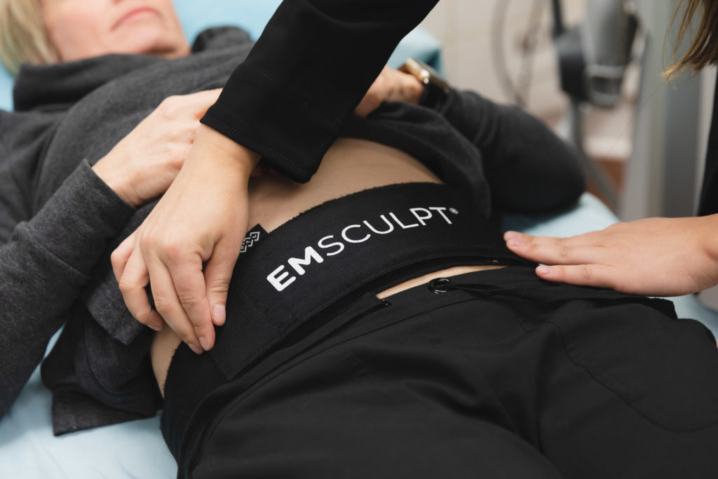 Photo of woman receiving Emsculpt treatment at a medspa in Starkville
