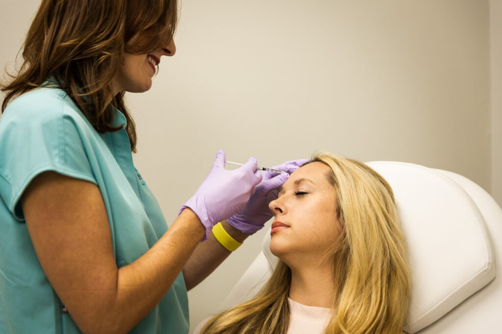 A Revive technician administers an injection at a medspa in Starkville