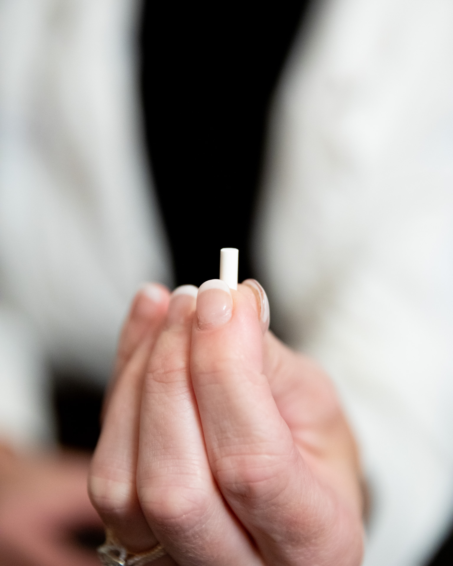 Provider holding a hormone replacement therapy pellet at Revive Wellness Clinic
