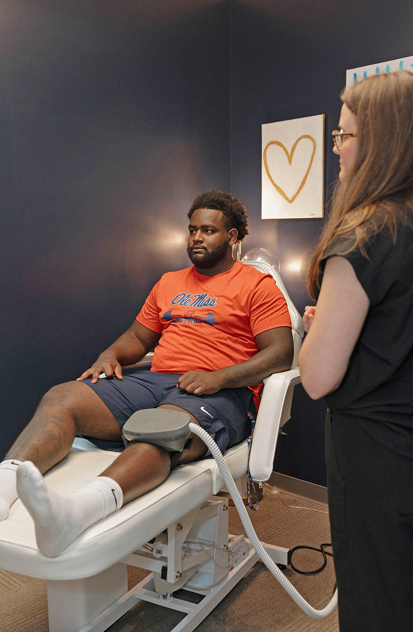 College athlete receiving Emsculpt Neo sports recovery treatment in Oxford Mississippi