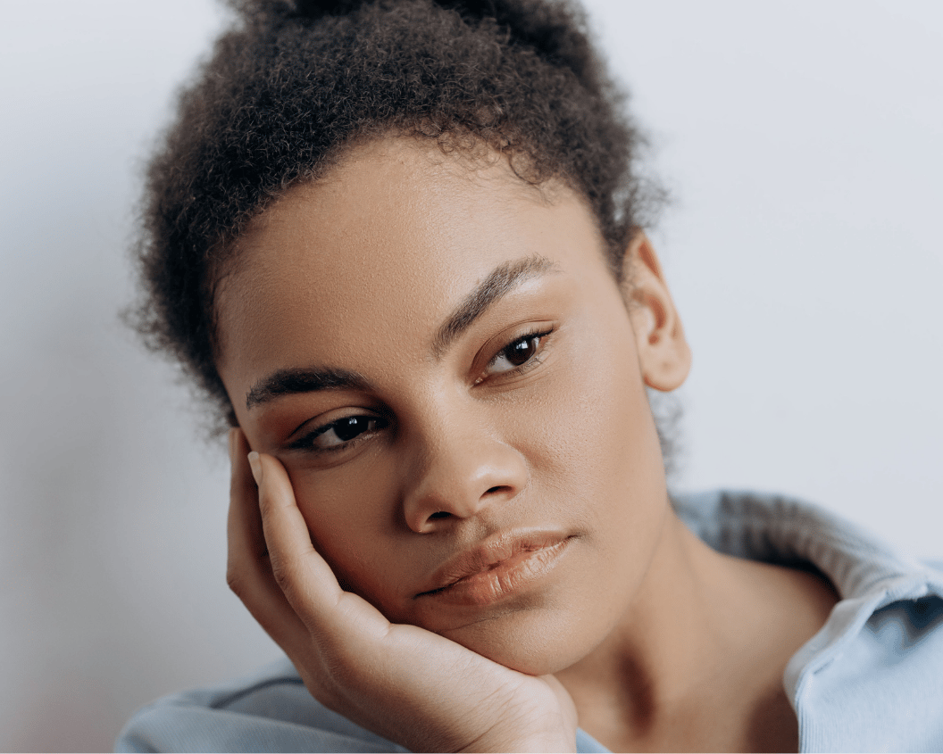 Woman holds her jaw like she is in pain.